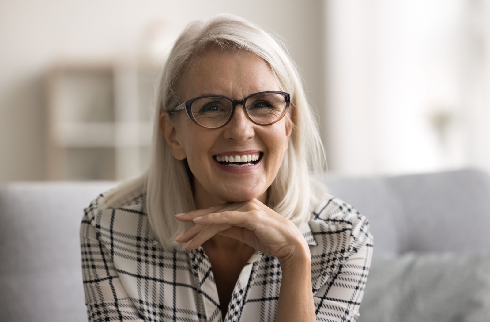 A patient smiling while wearing dentures.